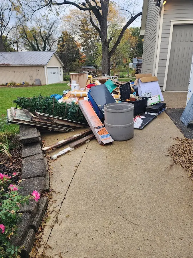 Dumpster being loaded with debris for Commercial Dumpster Rental in Glens Falls